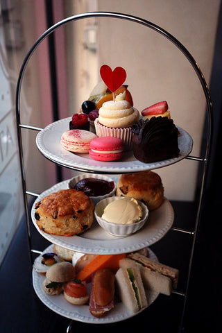 A high tea stand laden with treats.