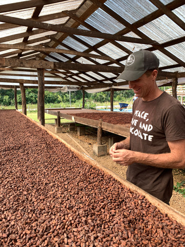chris tasting dried cacao beans at Maya Mountain Cacao