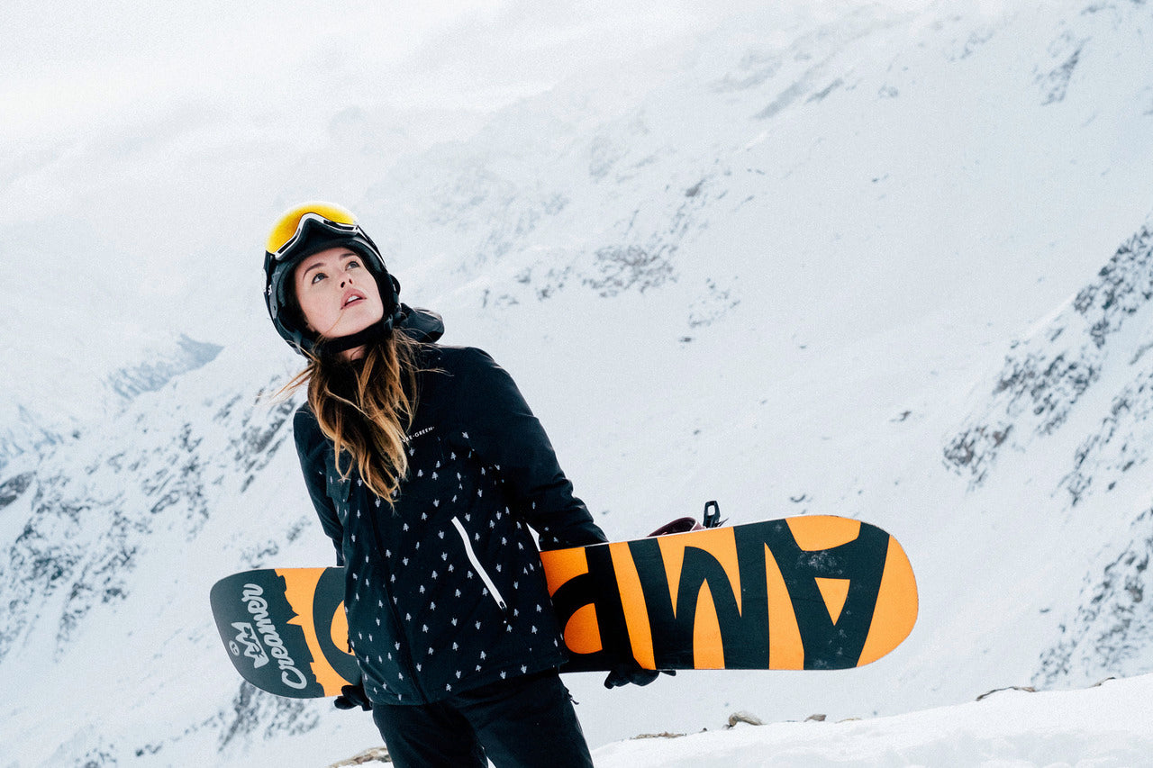 Girl with snowboard at the snow