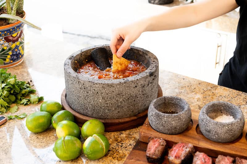 Craft by Order - Volcanic Stone Molcajete "Chilmamolli" - 10-inch Volcanic Stone Bowl with Parota Wood Base, 50 Oz Capacity