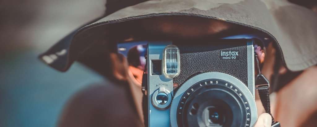 Man with bucket hat and camera