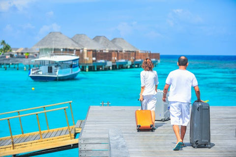 Two people on a dock with suitcases