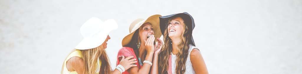 Women wearing straw beach hats