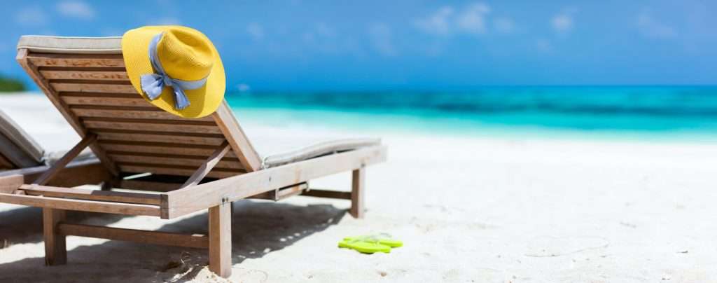 fashionable sun hat on a beach chair