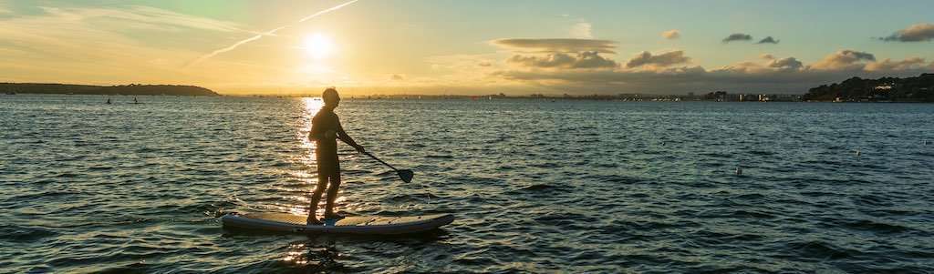 Sunset paddleboarding with UPF apparel