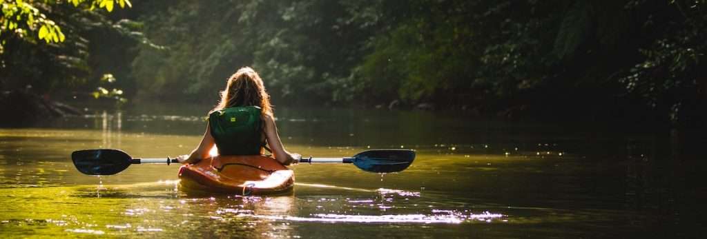 Female Athlete Kayaking with Sun Protection