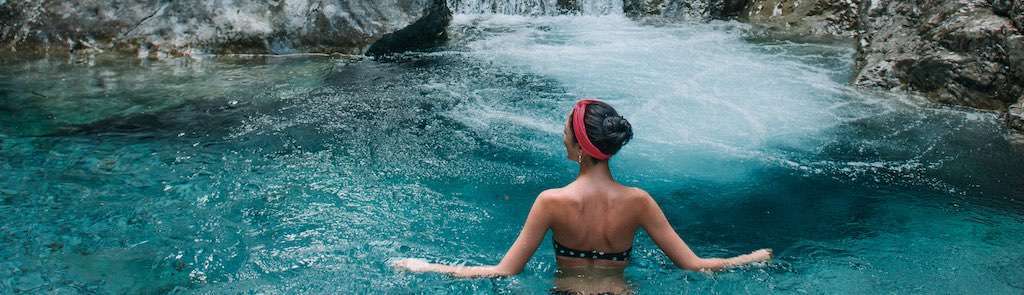 Woman swimming with UPF headband gaiter