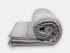 The rolled-up grey Fiora weighted blanket that brings comfort.
