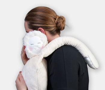 A person hugging HUG: The Comforting Companion designed for people living with dementia.