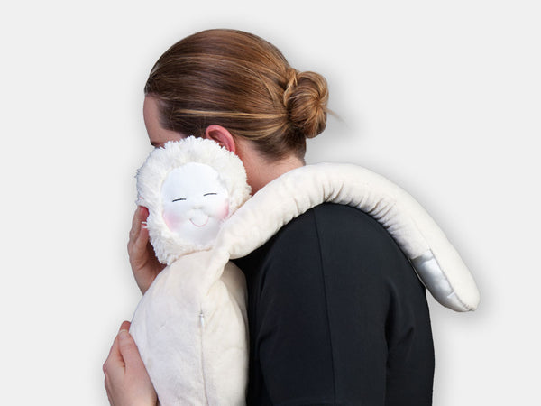 A person hugging HUG: The Comforting Companion designed for people living with dementia.
