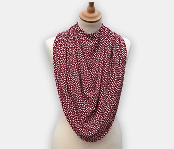Protective pashmina bib for older adults in burgundy with white polka dots pattern.