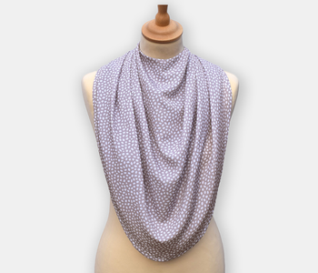 Protective pashmina bib for older adults in the grey with white polka dots pattern.