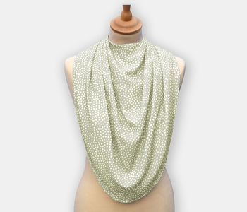 Protective pashmina bib for older adults in the light green with white polka dots pattern.