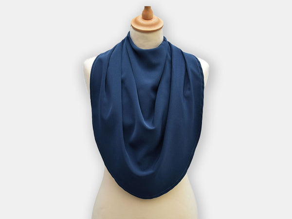 Protective pashmina bib for older adults in the dark blue color.