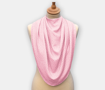 The dignifying protective pashmina bib for older adults in the pink with white polka dots pattern.