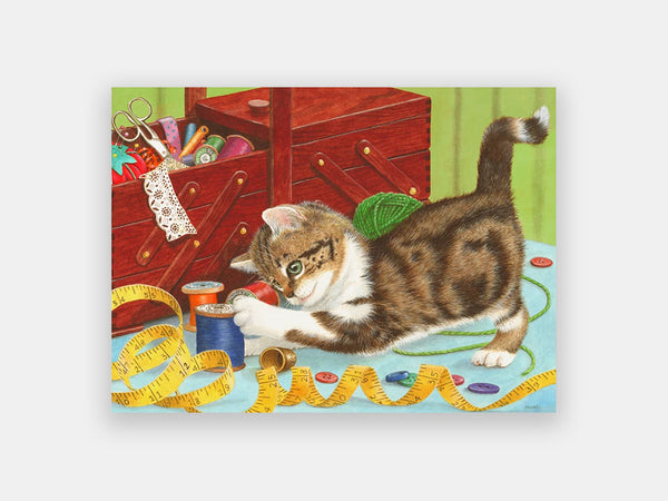 Adapted 13-piece Relish puzzle of a brown and white kitten playing with sewing accessories.