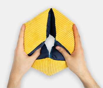Hands holding the yellow and blue rhythmic Relish tactile-turn designed for fidgety hands.