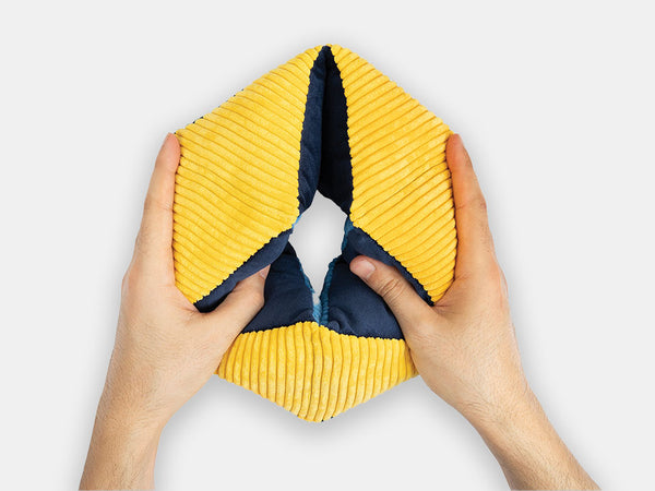 Hands holding the yellow and blue rhythmic Relish tactile-turn designed for fidgety hands.