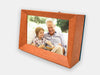 Familink 7-inch digital frame showing a grandpa and his grandson smiling while reading a book together.