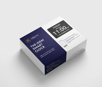 The Idem Smart Calendar Clock packaging showing the clock and a phone with the caregiver app features.