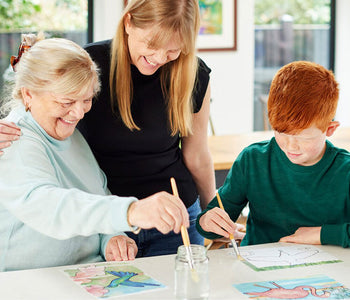 Older woman with her grandson and her caregiver, painting the water activated Relish Aquapaint set.