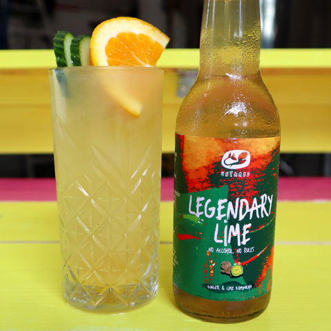 Legendrick's kombucha cocktail in a tall glass with cucumber, orange and Legendary Lime kombucha