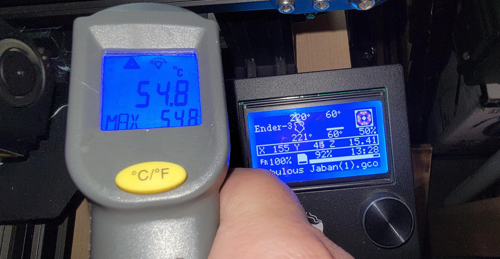 A thermometer showing ideal bed temperatures for popular filaments.