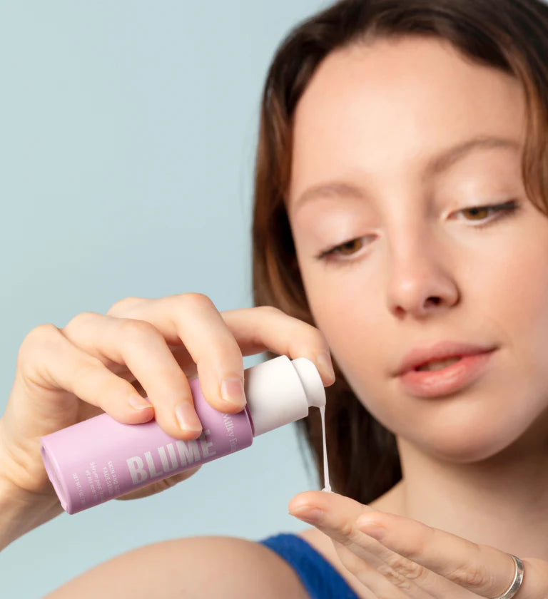 Person using a cotton pad on their face.