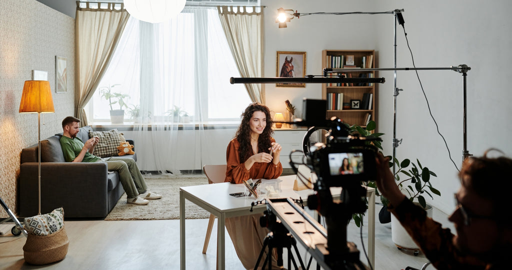 A person being interviewed and filmed in her office.