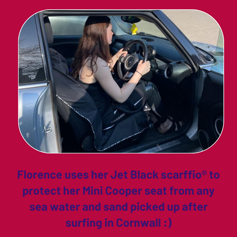 This photo shows a profile of a young lady in a wetsuit, driving home after surfing in cornwall. Her car seat won't get wet as she has a jet black scarffio® protecting her seat.