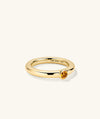 Gold ring with a round yellow gemstone, perfect for stacking and enhancing your ring collection.