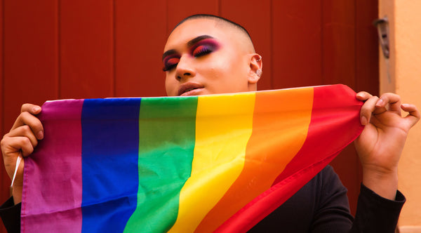 Rainbow flag being held by LGBTQ person at Pride