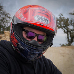 Jake wearing Flying Eyes Osprey sunglasses with mirrored purple lenses under his helmet