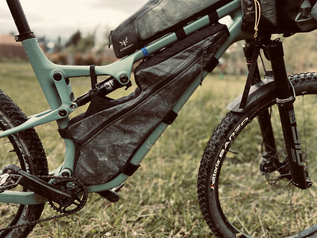 A bikepacking frame pack on a full suspension mountain bike