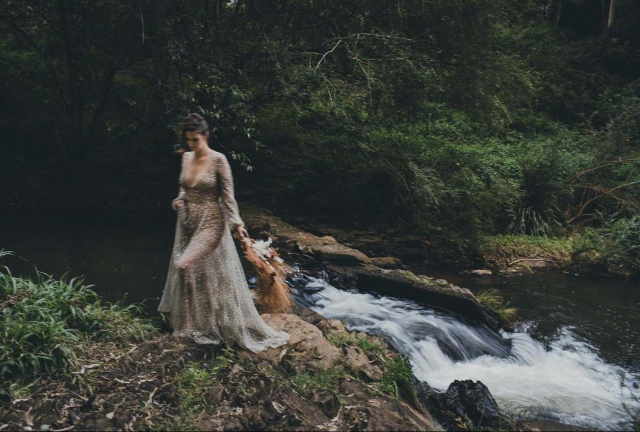 Ethereal bride by a waterfall