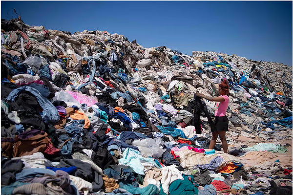 Landfill full of clothes, some of which have been barely worn because of the fast fashion industry.