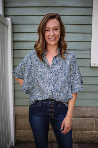 Teal blue abstract floral print button down top with ruffle sleeve and neckline detail