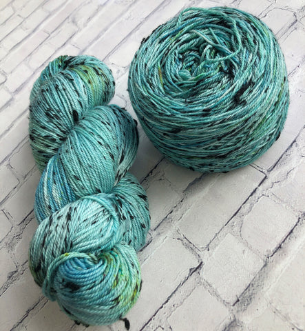 Teal yarn in a skein & cake