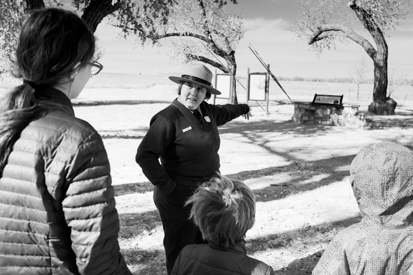 Children listen to National Park Ranger discuss Sand Creek Massacre
