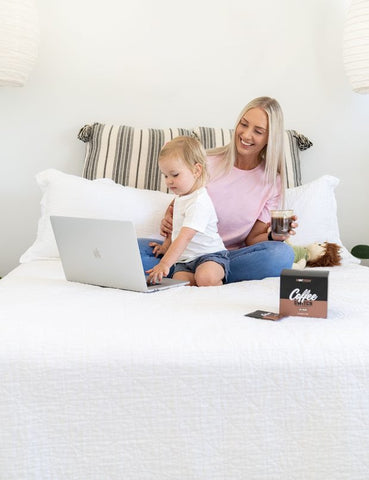 Mum on her laptop with toddler 