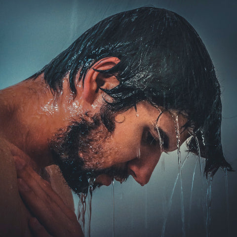 Man washing hair in shower