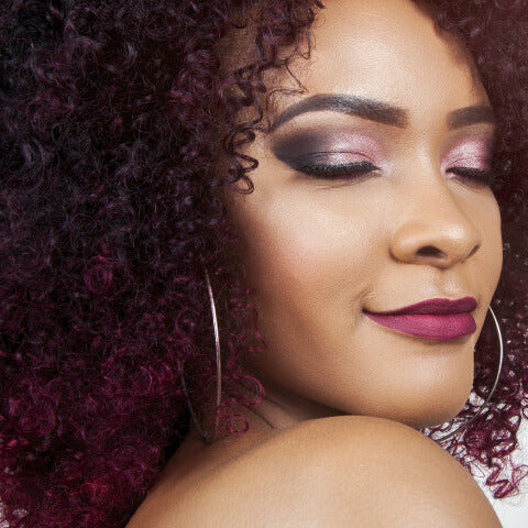 Woman with great curly hair and a contented look on her face