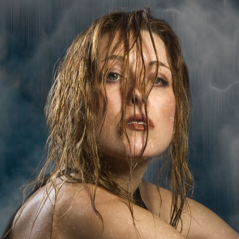 Woman with wet hair over face