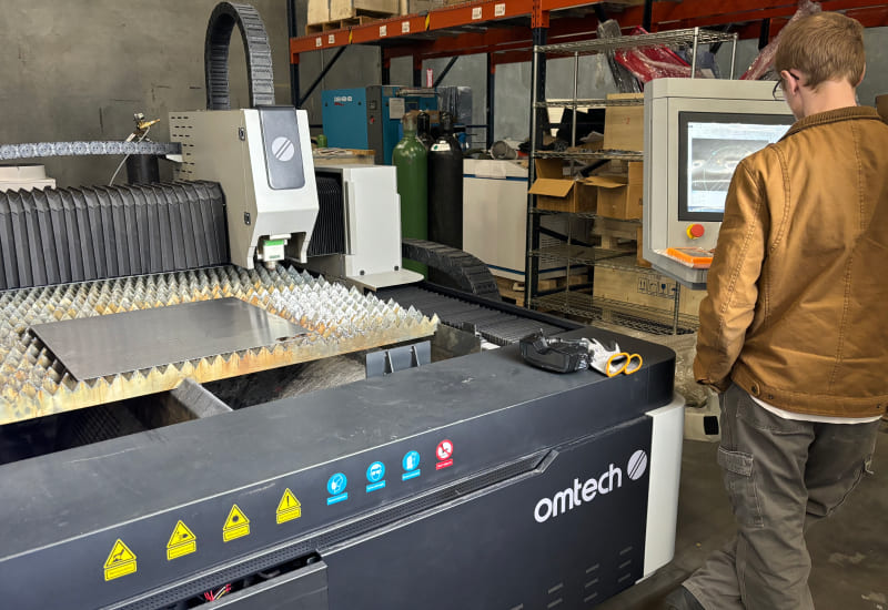 man changing laser power and cutting speed fiber laser settings