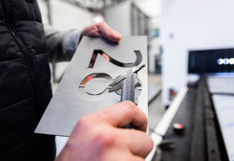 examining laser engraved metal sign
