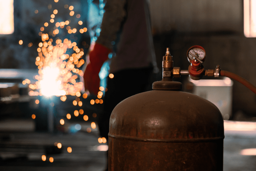 closeup of shielding gas. behind, metal welding