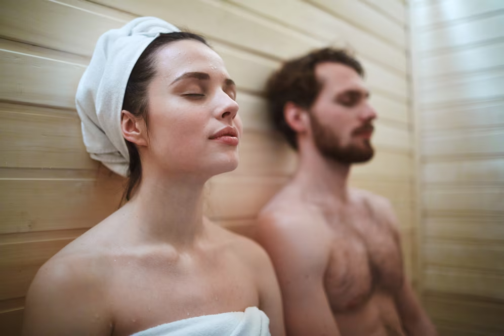 adult male and female relaxing in the sauna