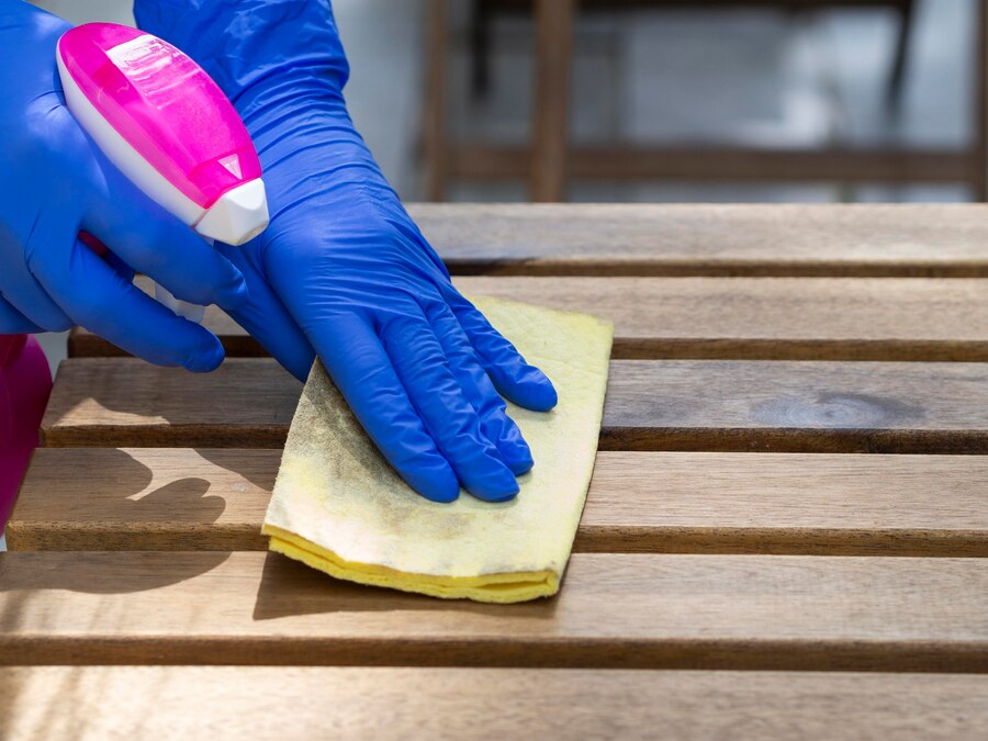 person cleaning wood surfaces