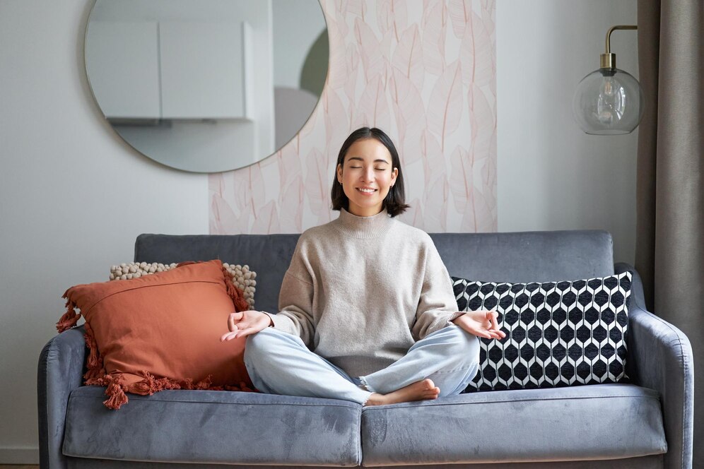 smiling woman sitting on couch relaxing
