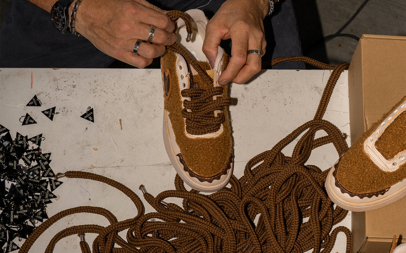 Quality control and addition of shoe laces